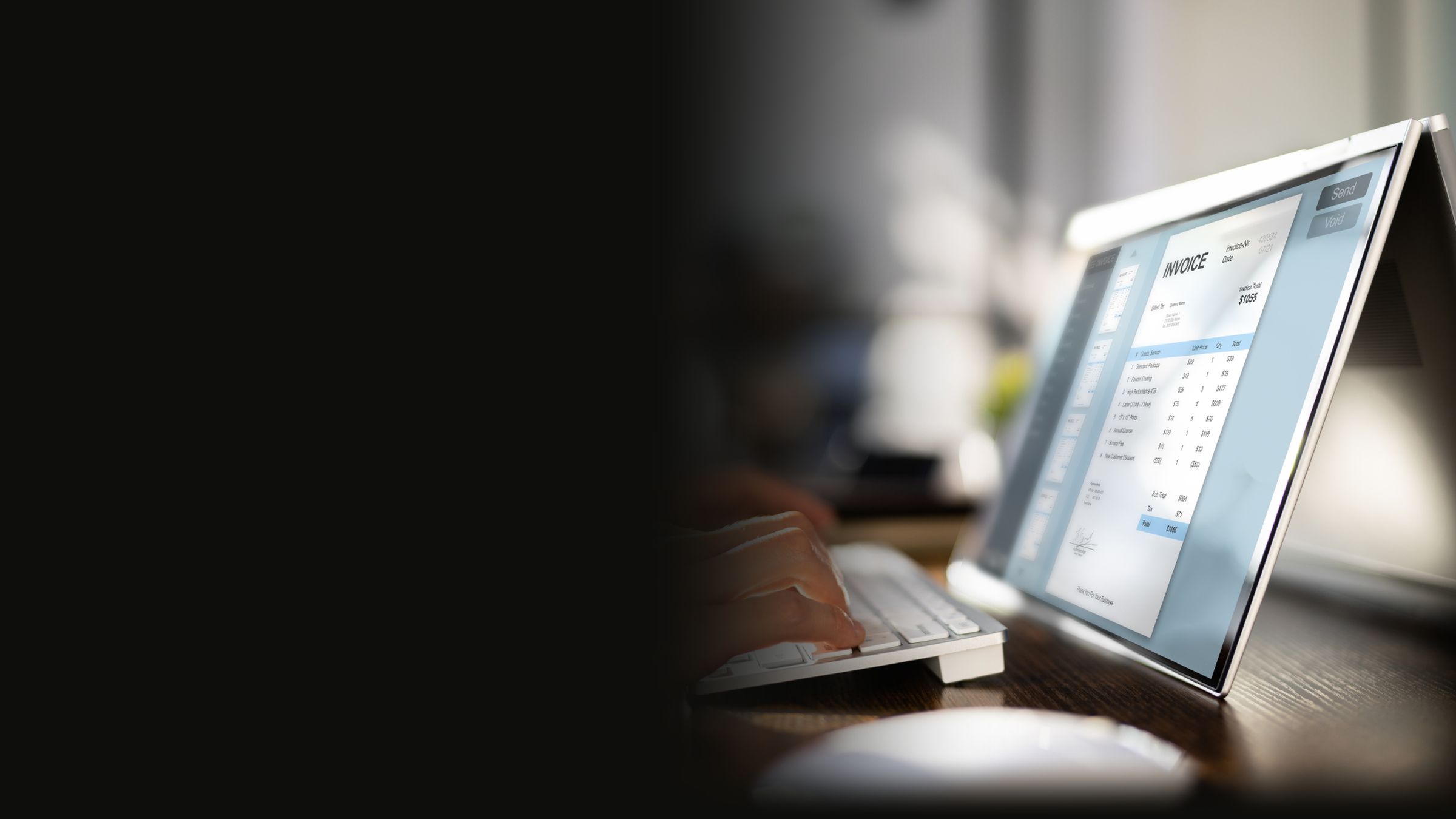Typing up an invoice on a laptop