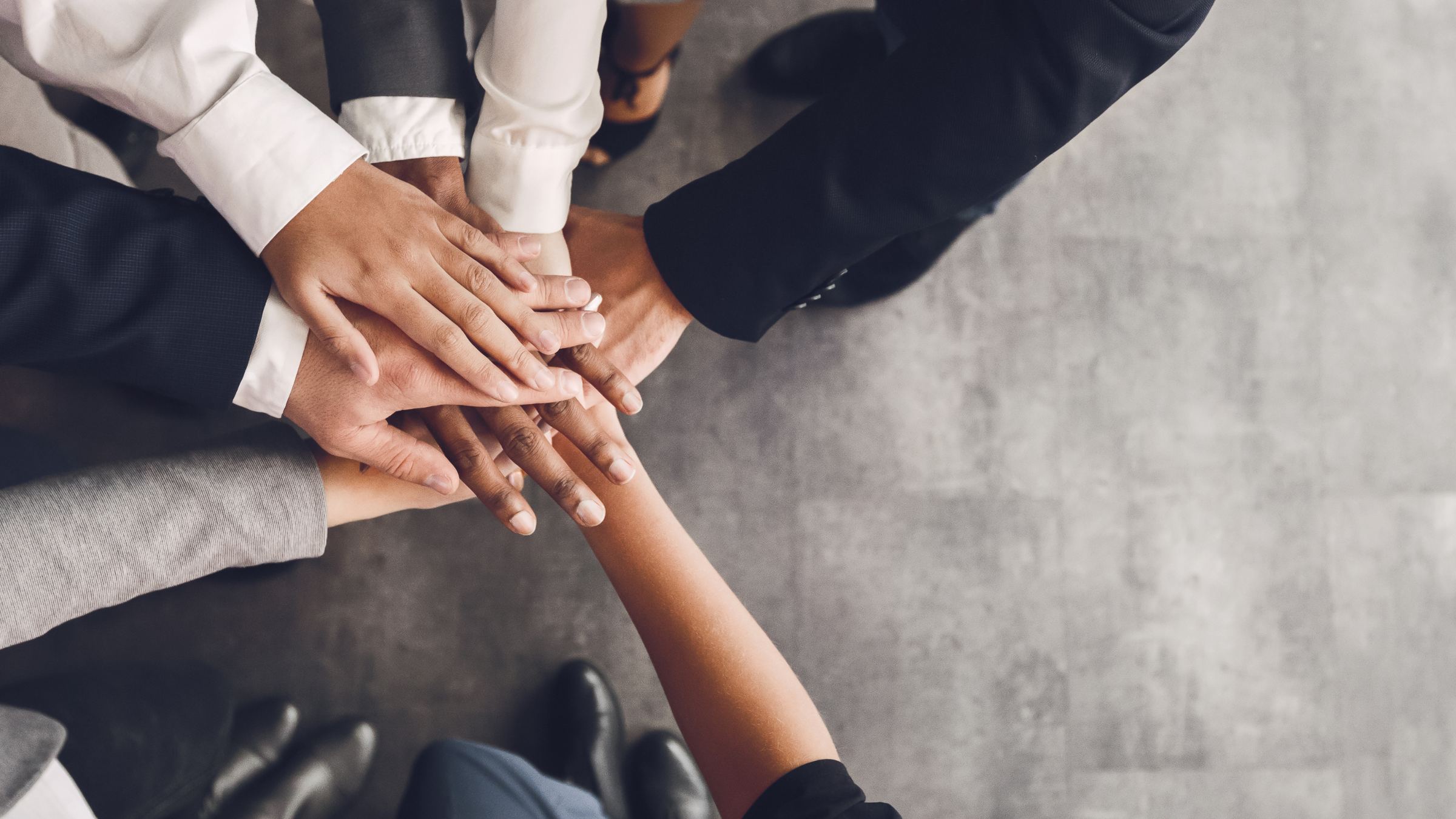 A team's hands joined together